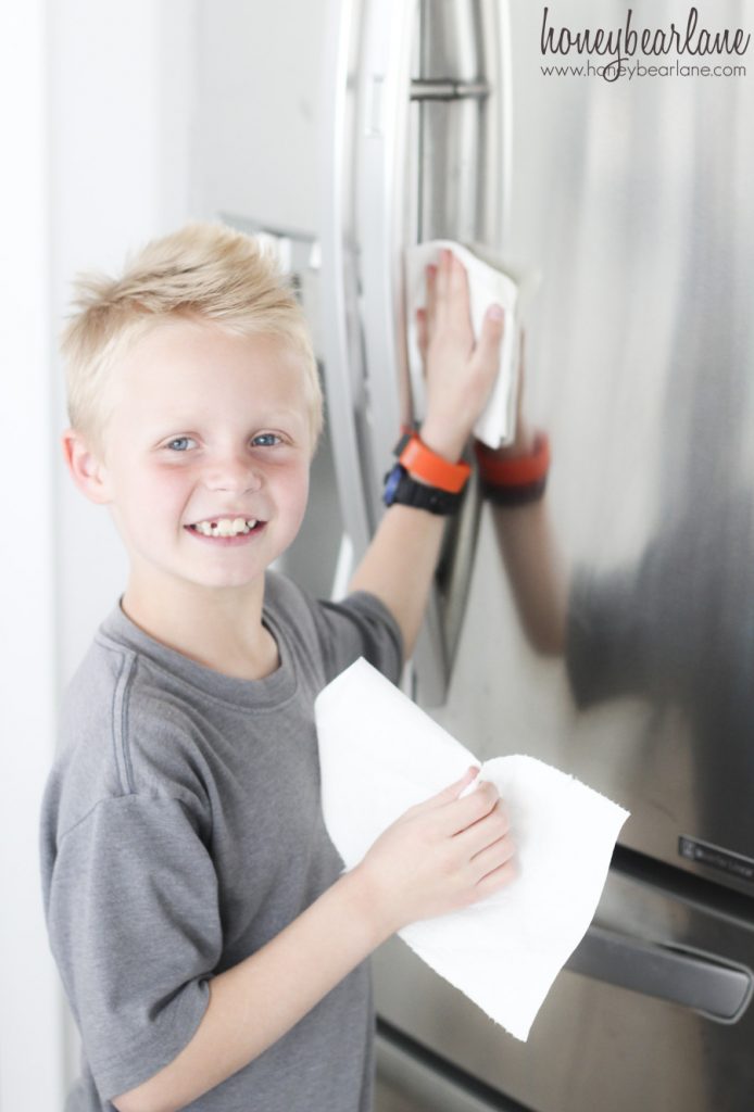 boy cleaning fridge