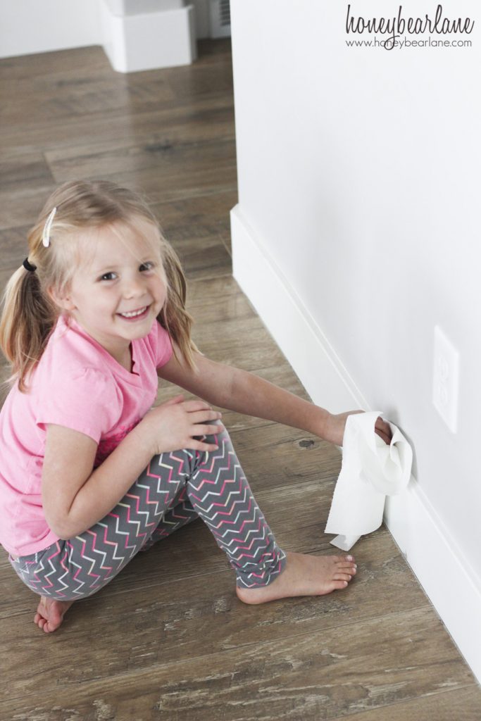 girl cleaning baseboards